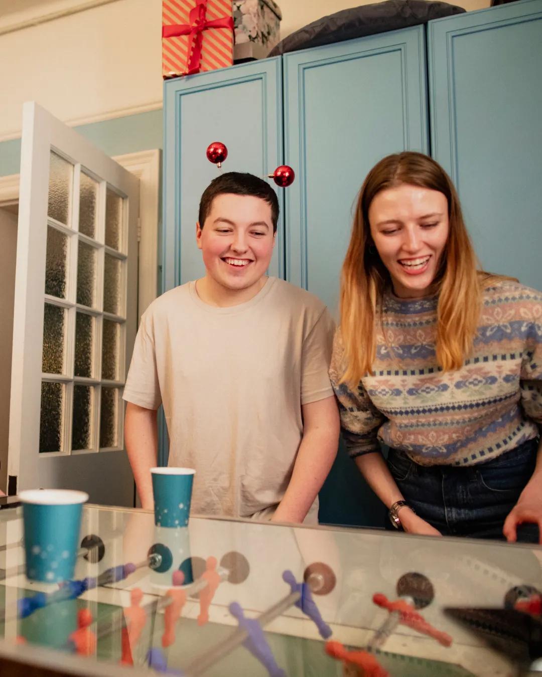 Two young people playing games at a party