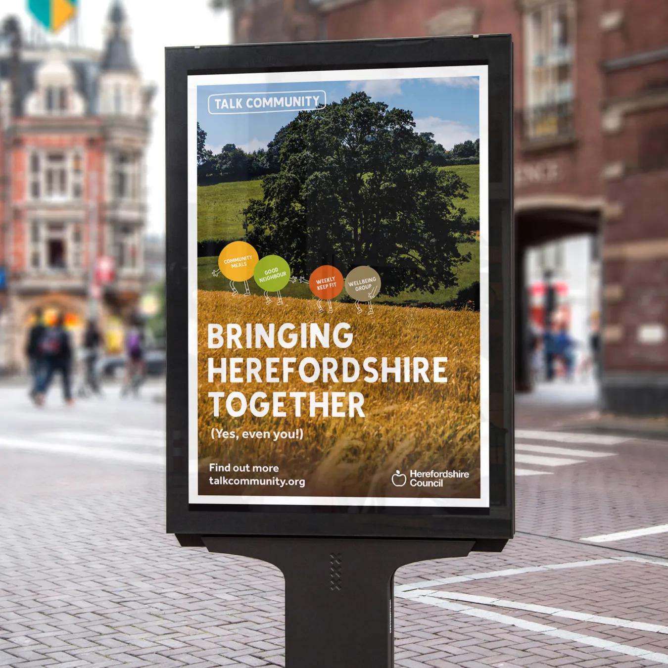 Outdoor advertisement with the caption 'bringing herefordshire together'