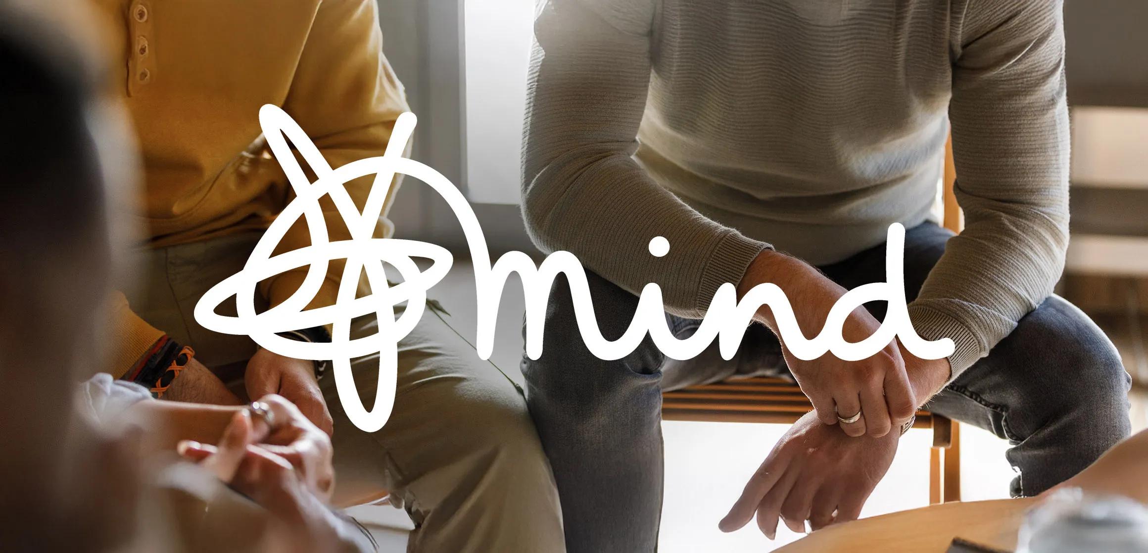 Photo of people during a group therapy session with the mind logo on top