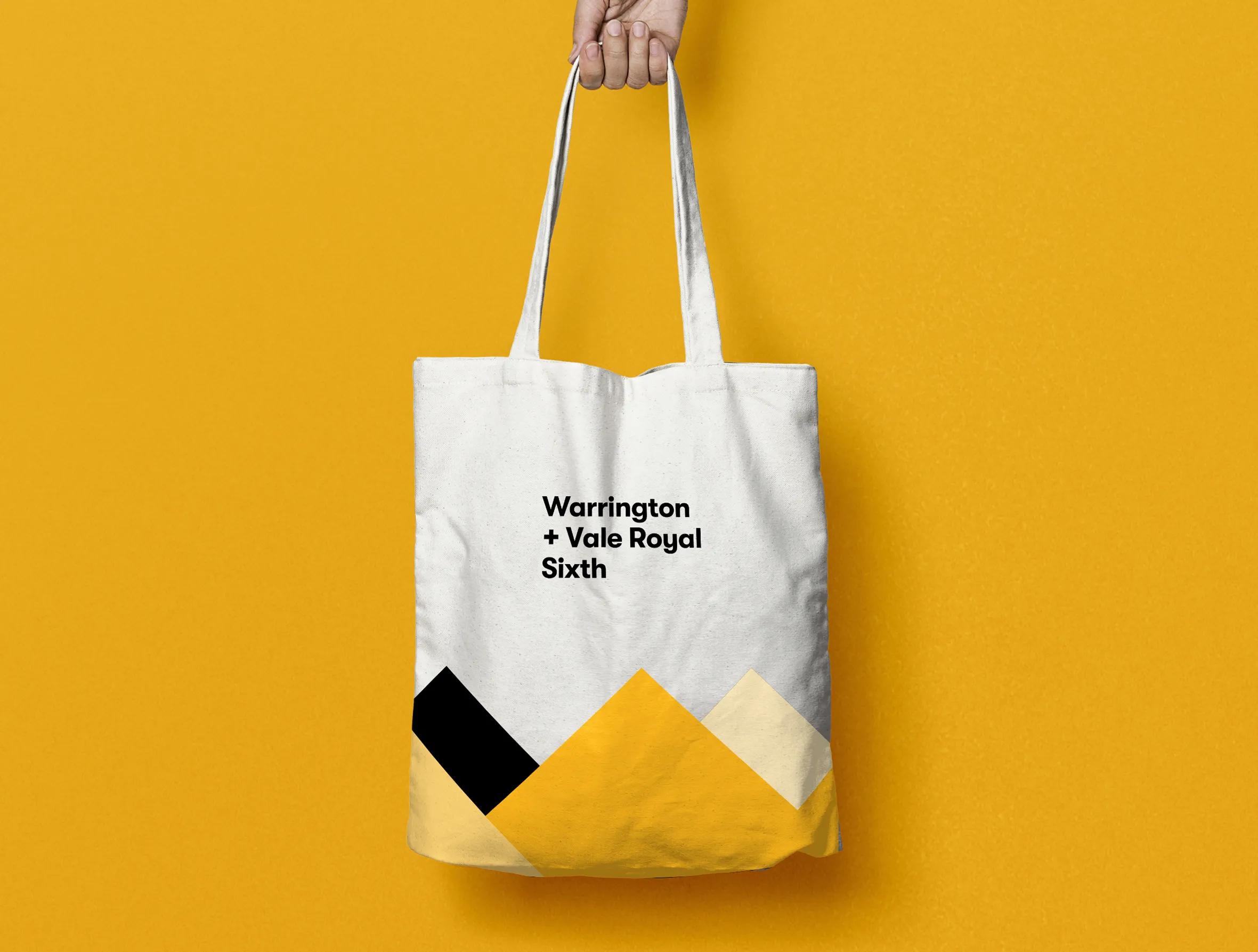 Branded white tote bag with yellow and black details