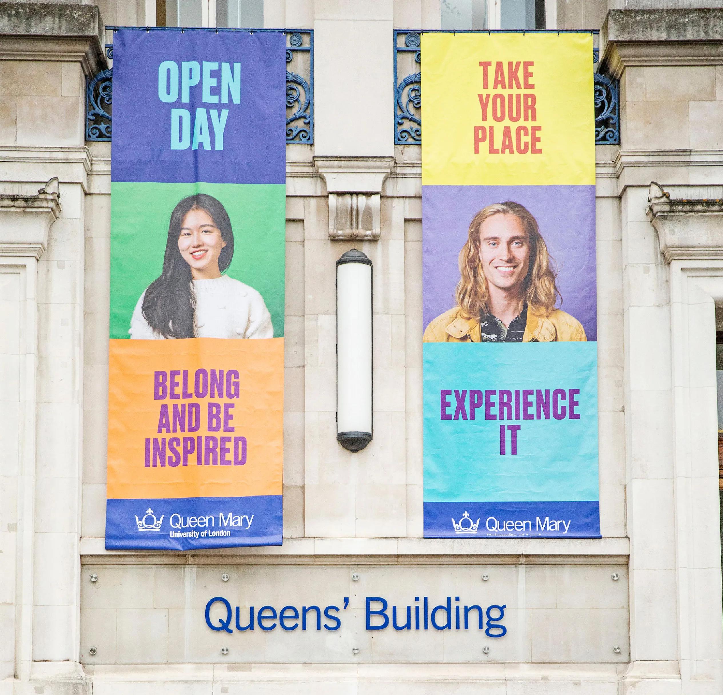 Two banners hanging from the university building