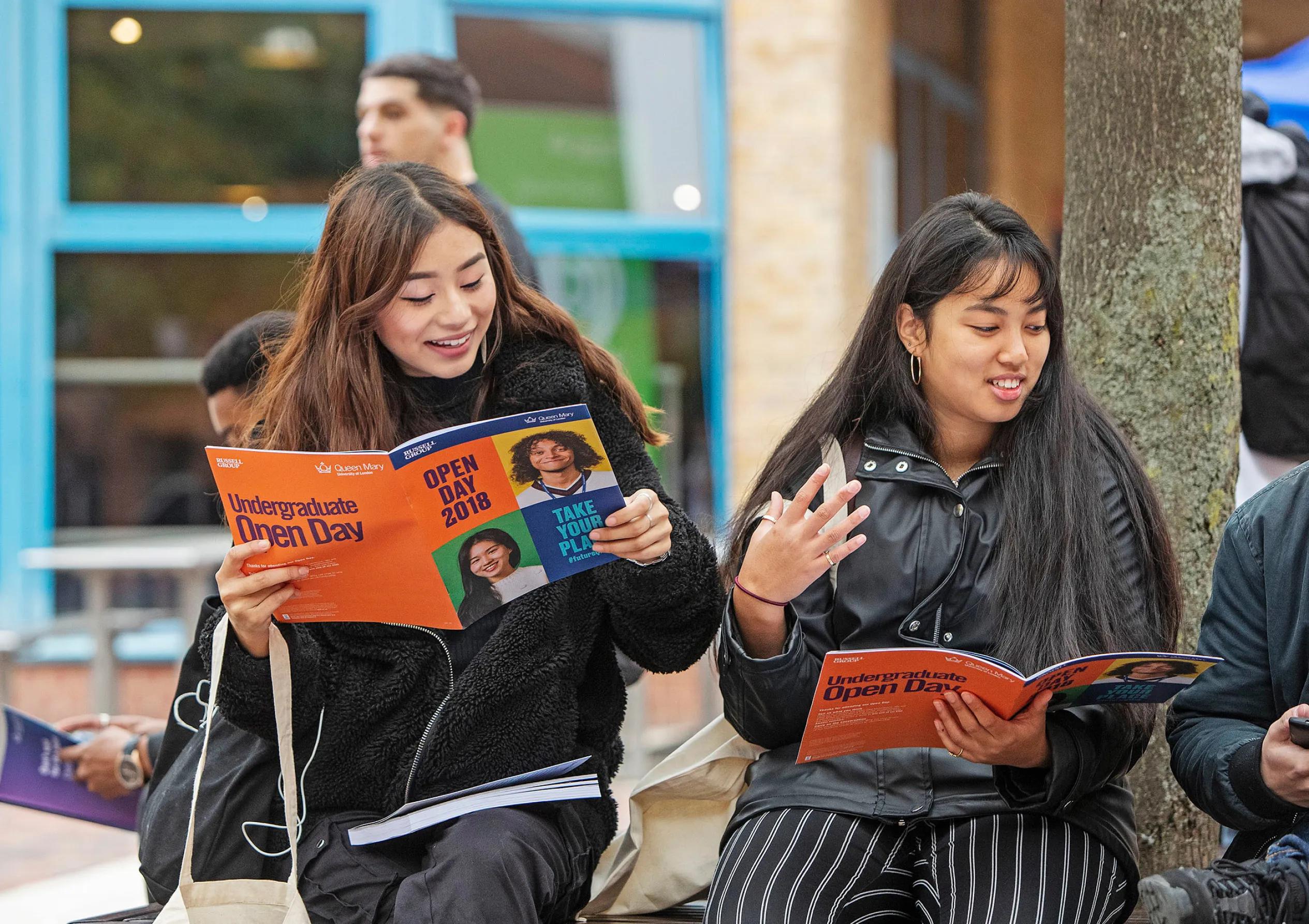 Two girls looking at the brochure