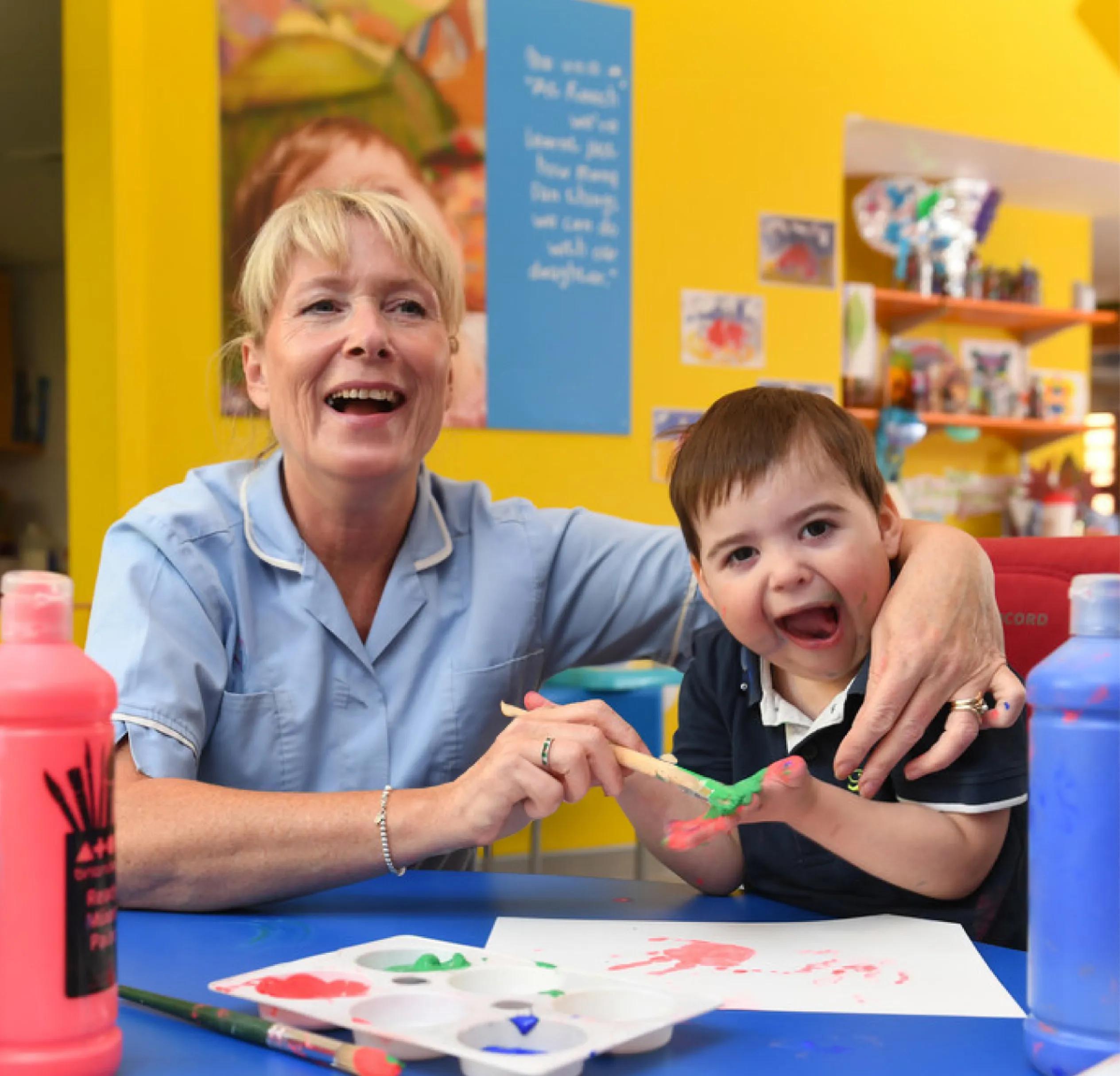 Nurse painting with one of the child patients