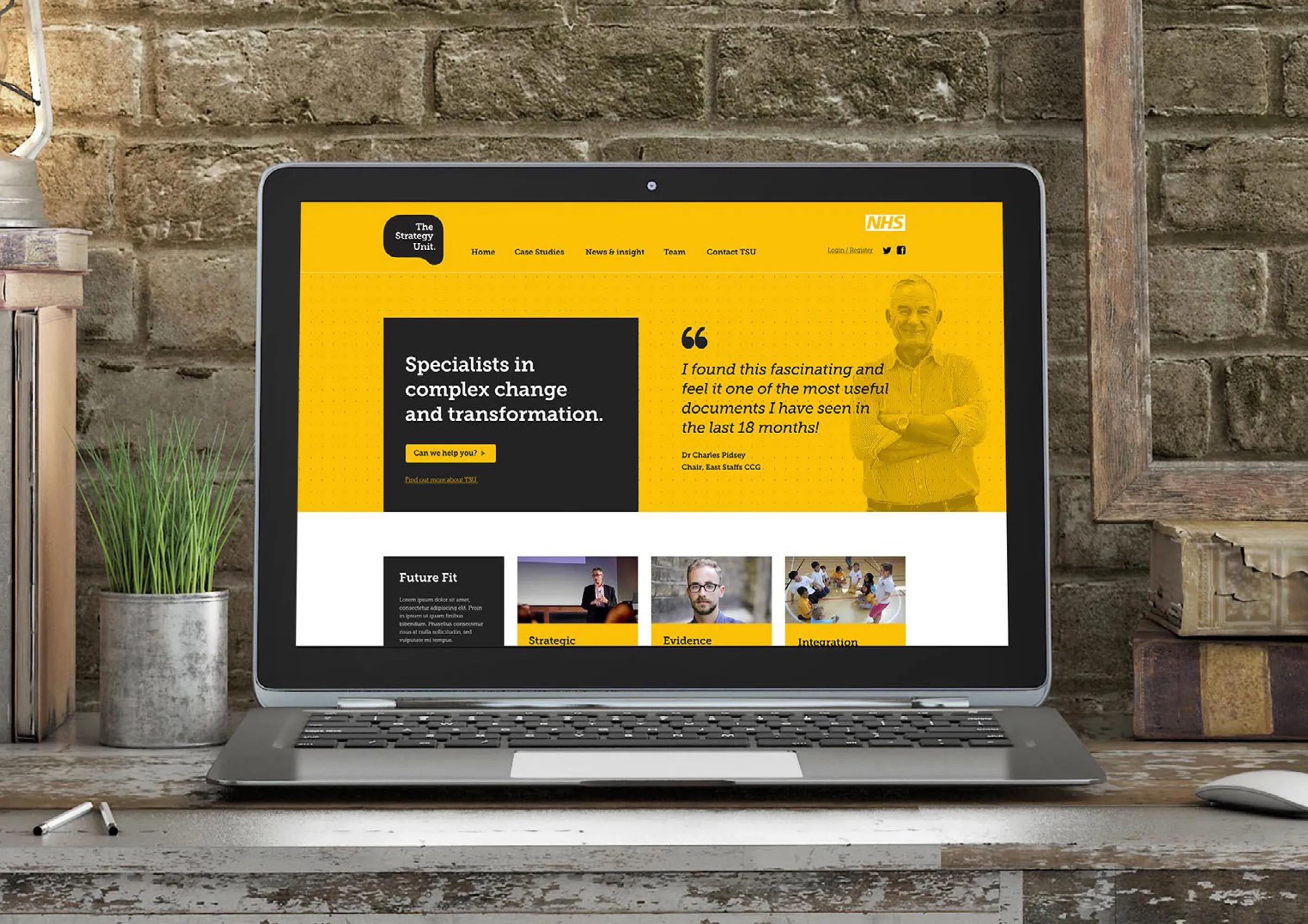 Laptop displaying the homepage of the website