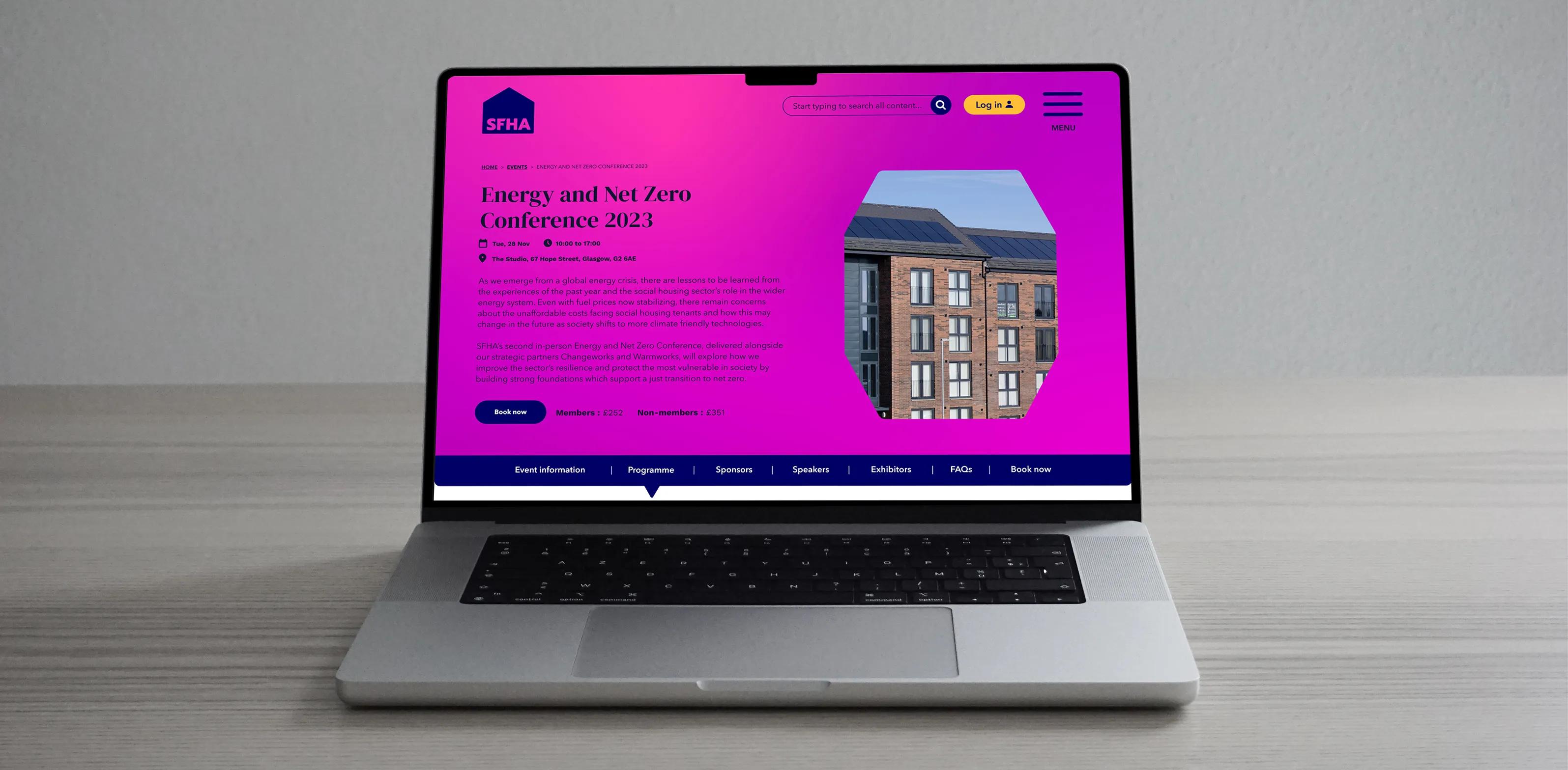 Conference landing page displayed on a laptop