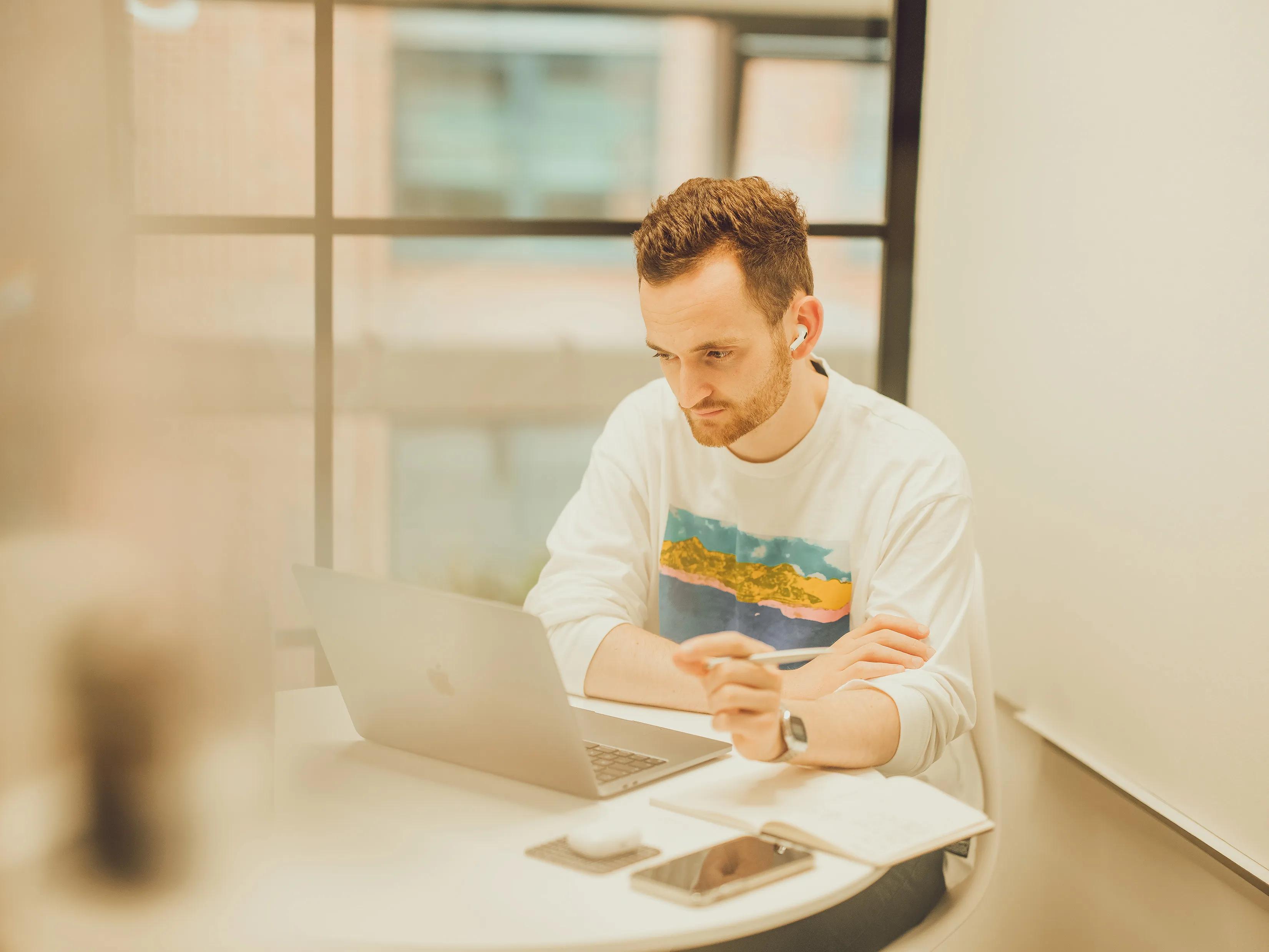 dan on a meeting on his laptop
