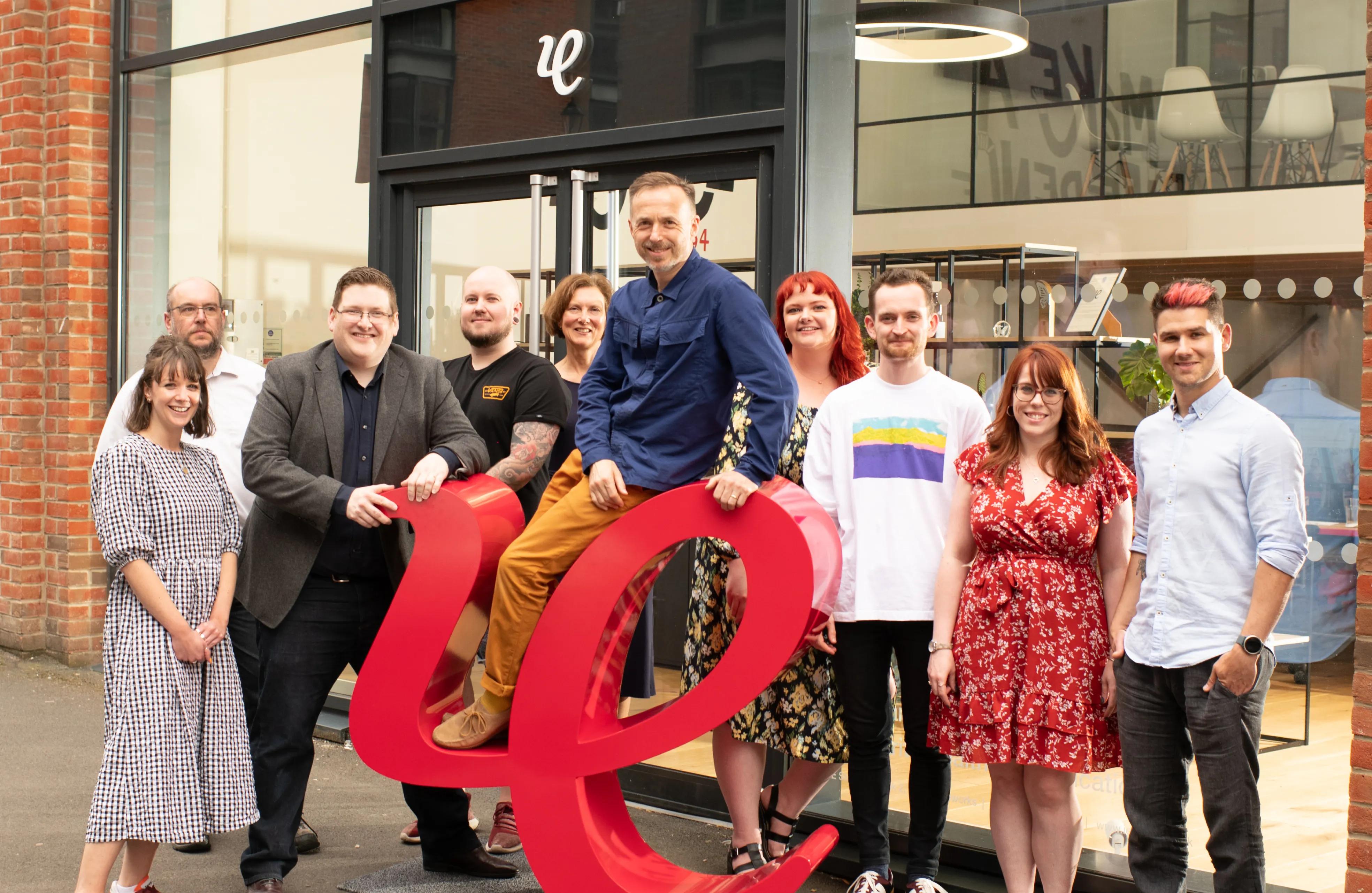 IE team standing outside of the studio